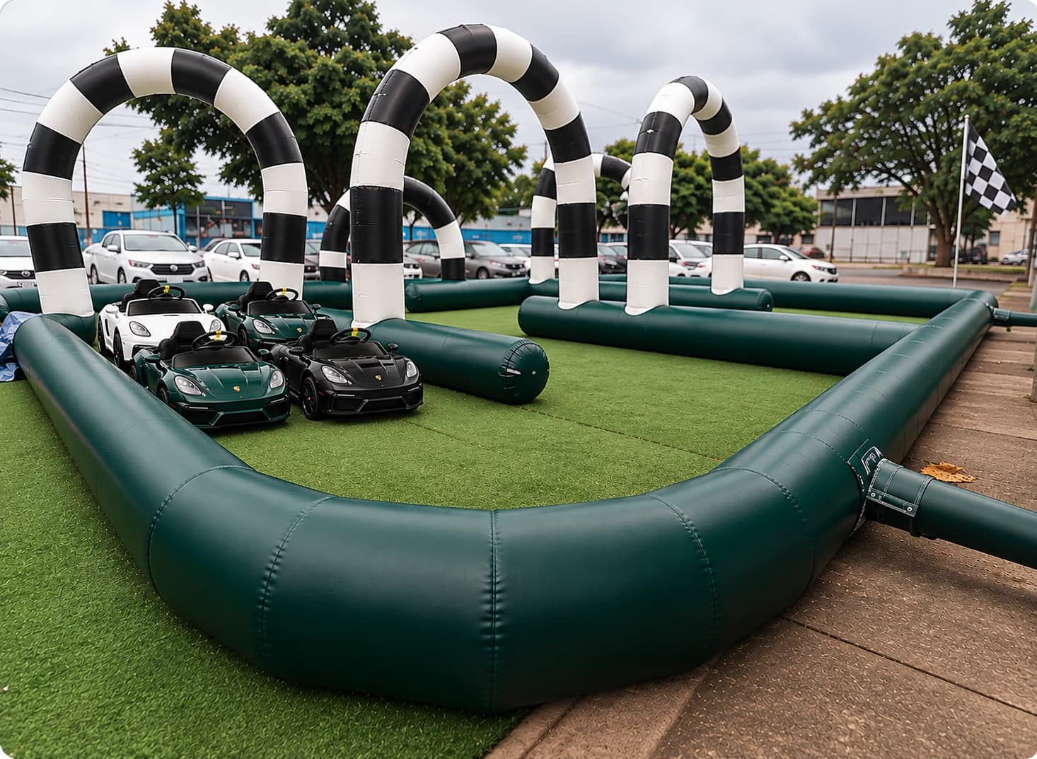 Mini Grand Prix racing track in racing green with checkered arches and four miniature cars lined up